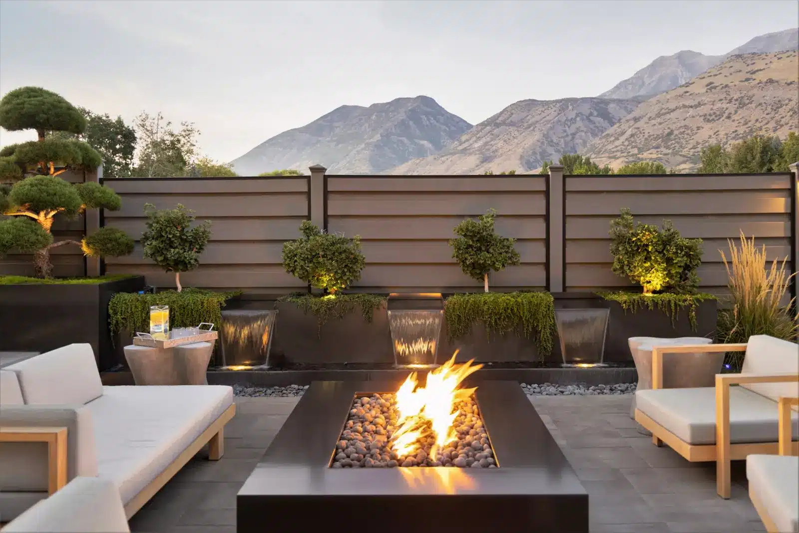 Modern Backyard Fencing Ideas 8 Beautiful brown Trex fence with a lawn and garden.