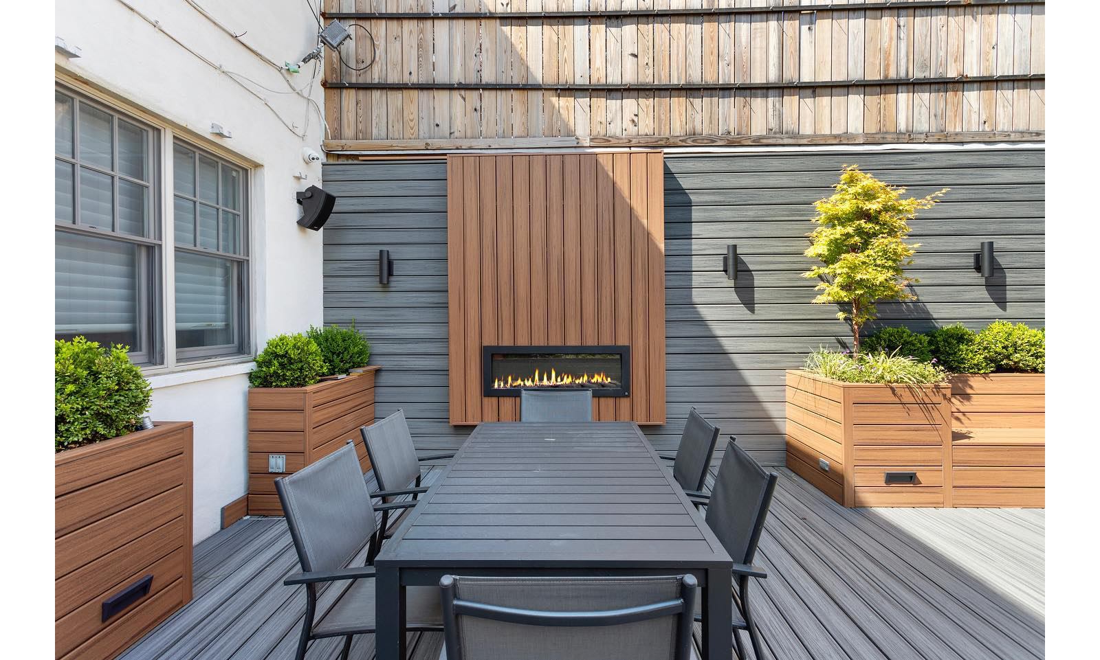 Modern Backyard Fencing Ideas 9 Beautiful brown Trex fence with a lawn and garden.
